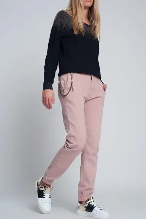 Cuffed utility pants with chain in pink